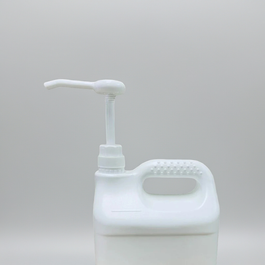 White plastic bottle with pump on a light gray background