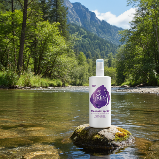 Bottle of So Pure mosquito spray on a rock by a river with mountains in the background