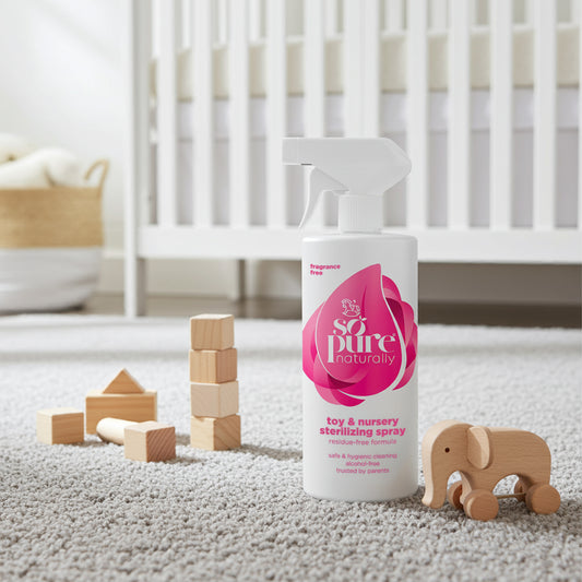 Spray bottle labeled 'so pure naturally' in a nursery setting with wooden blocks and an elephant toy.