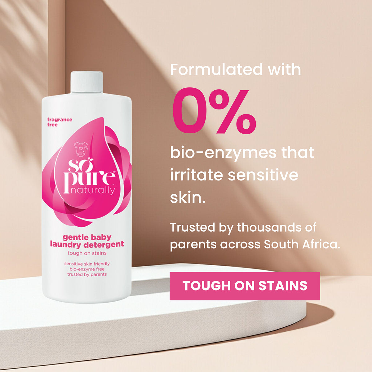 Bottle of 'so pure naturally' gentle baby laundry detergent with text highlighting features on a beige background.