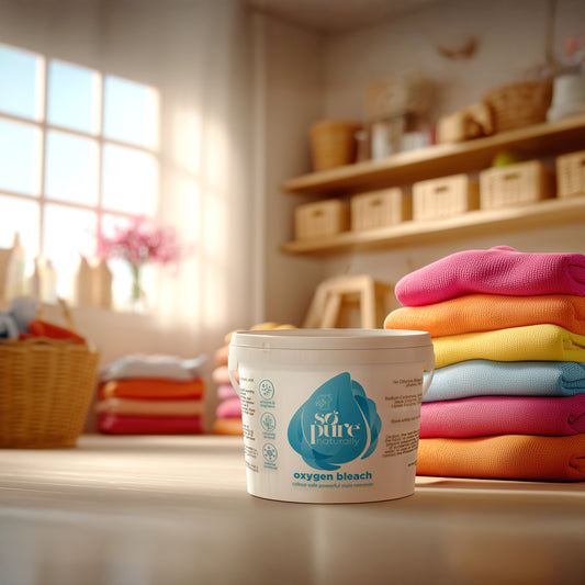 Container of 'so pure' oxygen bleach with a stack of colorful clothes in the background.
SoPure Oxygen Bleach SoPure Naturally - Eco Friendly Anti Allergen Natural Cleaning Products